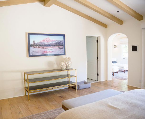 Bedroom with a Samsung frame TV and Smart Home Control Touch panel on the right in Encino